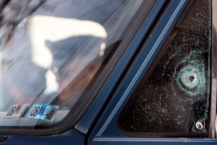 Cops search the bullet-riddled van used in attempt to strike officer.