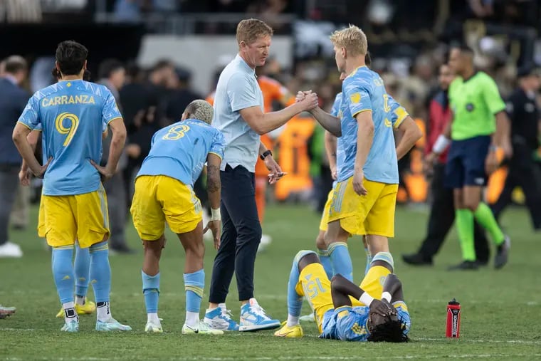 Union manager Jim Curtin (center) tries to console his players after their MLS Cup final loss to Los Angeles FC.