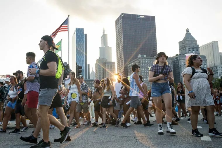 Attendees walk along South Columbus Drive during the first day of Lollapalooza in Grant Park on July 29 in Chicago.