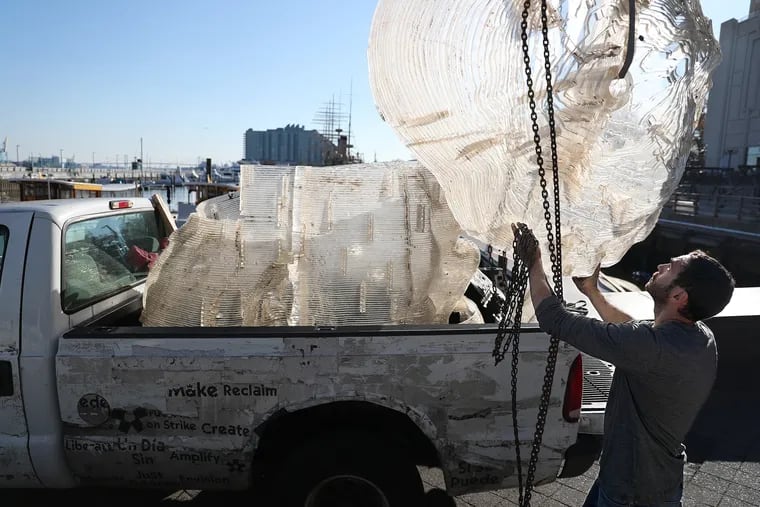Philadelphia artist Miguel Horn, guides a piece of his sculpture titled, Abu, into the back of a pick-up truck next to the Independence Seaport Museum in Philadelphia, PA on November 6, 2019. Horn's sculpture was damaged in last week's storm. He plans to restore it at his studio. It was one of 10 floating sculptural installations outside the Independence Seaport Museum collectively called Flow