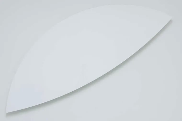 Kelly's &quot;Two Curves&quot; (2012) is elegantly minimal. The top edge nearly dissolves against the pale wall, while the bottom curve, accented by deep shadow, stands out in bold relief.