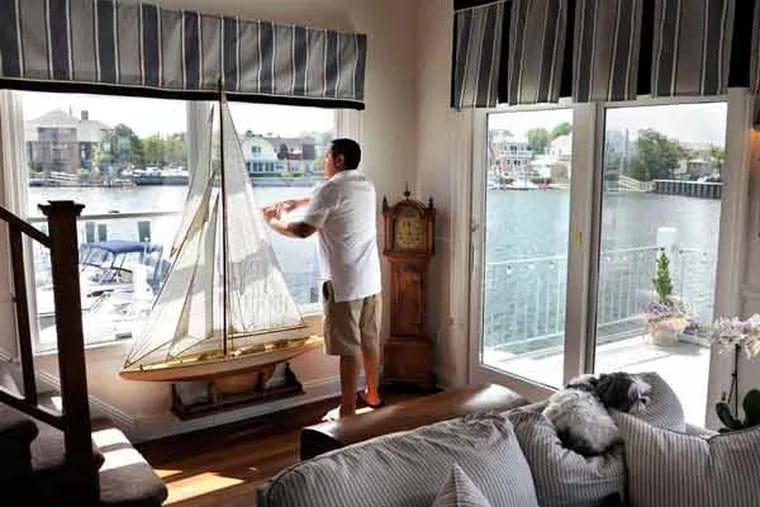 Jimmy Ruiz looks toward the water from the living room. A waterfront site was important to Ruiz and his partner. (TOM GRALISH / Staff Photographer )
