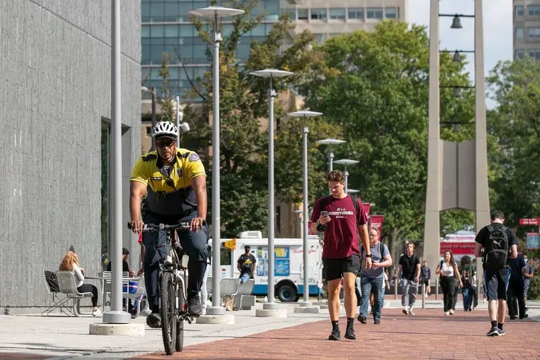 A Temple University police officer bikes around Temple's campus in Philadelphia.