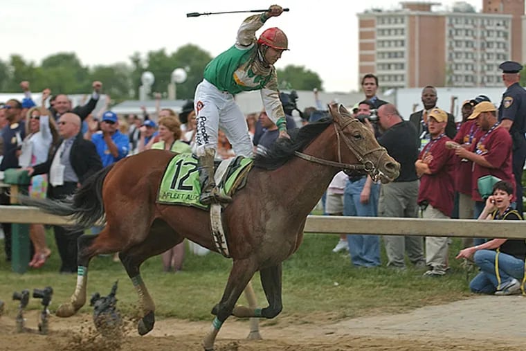 Jeremy Rose rejoices as Afleet Alex crosses the finish line ahead of the field on May 20, 2005. (Joan Fairman Kanes/Inquirer File Photo)