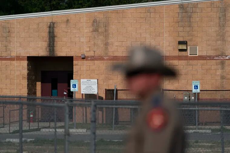 A back door at Robb Elementary School, where a gunman entered to get into a classroom in last week's shooting, is seen in the distance in Uvalde, Texas.