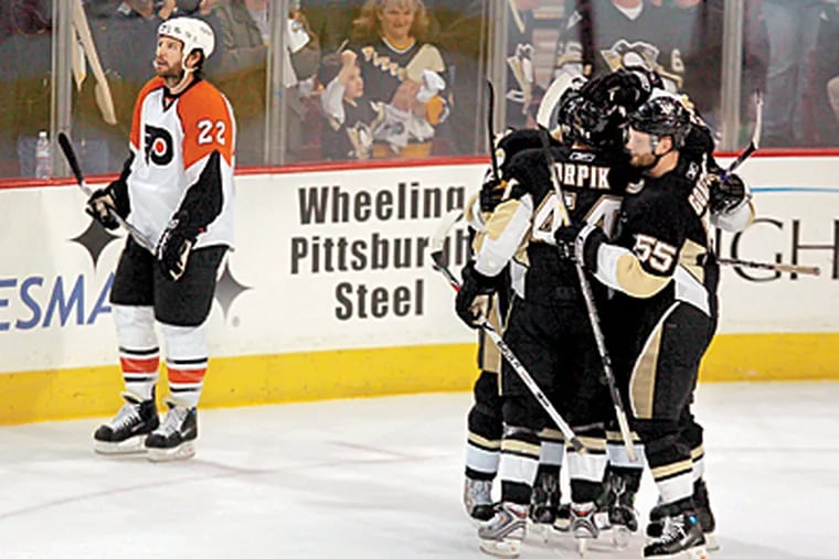 The Flyers’ Mike Knuble must endure the Penguins’ celebration after Jordan Staal scored an empty-net goal to seal the Game 2 win for Pittsburgh. (Barbara L. Johnston/Inquirer)