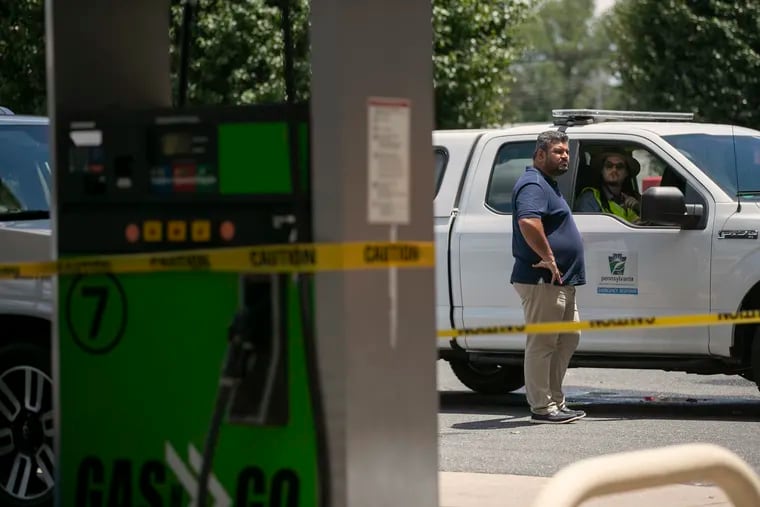 Raj Syan, left, owner of Gas ‘N’ Go at the corner of Coebourn Boulevard and Edgmont Avenue in Brookhaven, speaks Tuesday, June 15, 2021 with members of the Pennsylvania Department of Environmental Protection after a gasoline spill over the weekend on Tuesday, June 15, 2021.  Up to 4,700 gallons permeated the ground at Coebourn Elementary School next door to the gas station, and flowed into the retention pond.