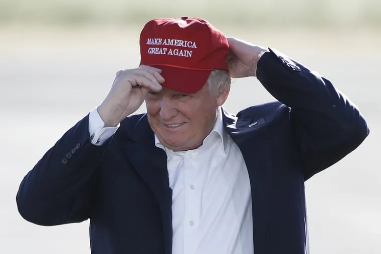 In this June 1, 2016, file photo, Republican presidential candidate Donald Trump wears his "Make America Great Again" hat at a rally in Sacramento, Calif.