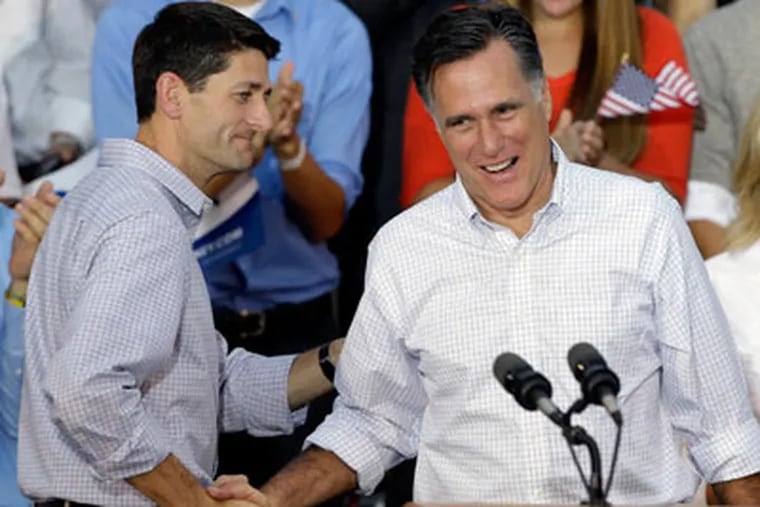 Republican presidential candidate Mitt Romney, right, is introduced by vice presidential running mate Rep. Paul Ryan, R-Wis., during a welcome home rally on Aug. 12, 2012, in Waukesha, Wis. (AP Photo/Jeffrey Phelps)