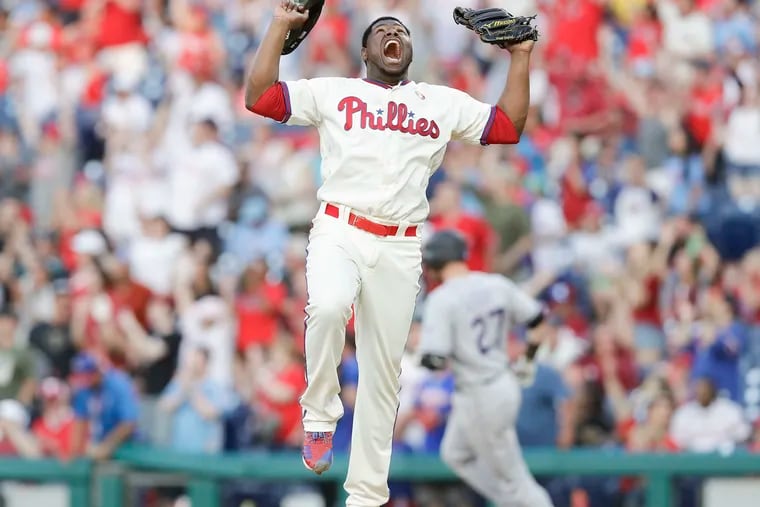 Phillies pitcher Hector Neris yells after getting Rockies Trevor Story to fly out for the final out of the game.