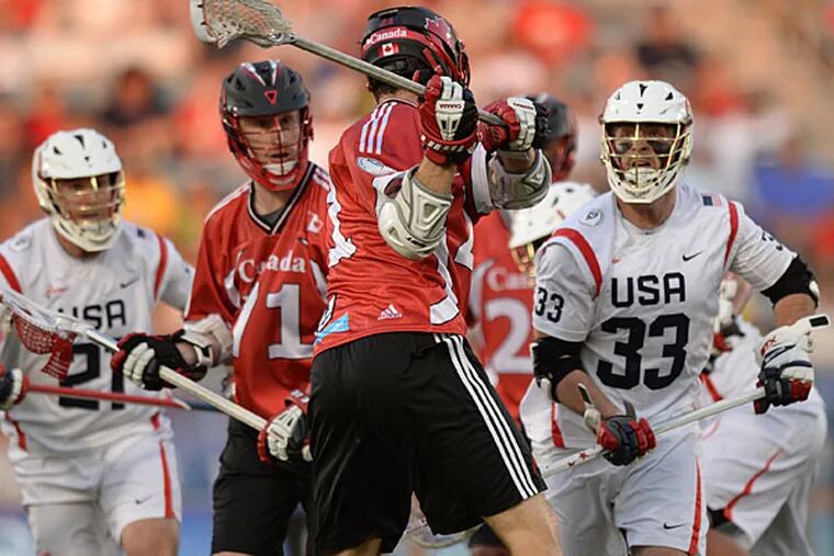 Canada midfielder Kevin Crowley (21) scores in the first half with a shot that he made behind his back against the United States an an FIL World Lacrosse Championship game Saturday, July 19, 2014, in Commerce City, Colo. (AP Photo/The Denver Post, Karl Gehring)