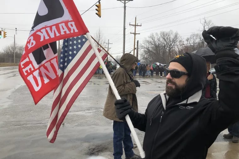 Bryan Pietrzak, a machinist and welder, joins in a United Electrical Radio & Machine Workers protest outside the Wabtec plant in Erie, Pa., last month. Pietrzak has seen his hours cut back as work at the plant has slowed.