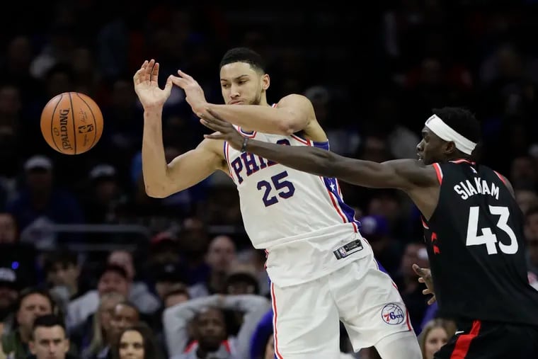 Sixers guard Ben Simmons loses the basketball after getting fouled by Toronto Raptors forward Pascal Siakam during the fourth-quarter on Saturday, December 22, 2018 in Philadelphia.  YONG KIM / Staff Photographer