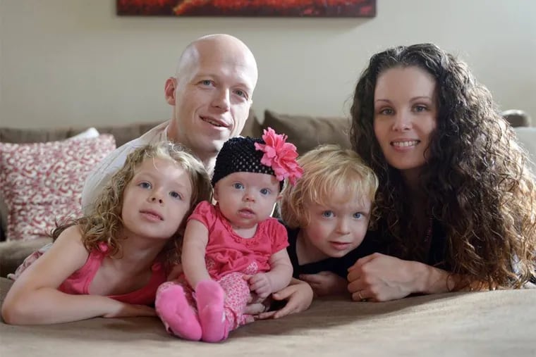 4-month-old Willow Short, center, who received a heart transplant when she was 6 days old, poses for a photograph with her parents Megan Short, top right, and Mark Short Sr., top left, her 6-year-old sister Liana, bottom left, and her 3-year-old brother Mark Jr., bottom right, in Sinking Spring, Pa.