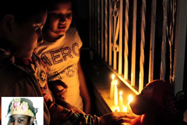 Police call the abuse death of 10-year-old Charlenni Ferreria (inset) one of the worse cases of abuse they've seen. Neighborhood children light candles and leave stuffed animals outside her home. ( Jason Melcher / Staff Photographer )