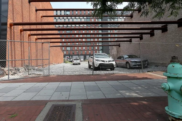 A cleared lot at 317 Market Street in Camden, NJ that Damon Pennington said will be a pop-up beer garden by August. On July 3, 2018 vehicles park on the lot. DAVID MAIALETTI / Staff Photographer