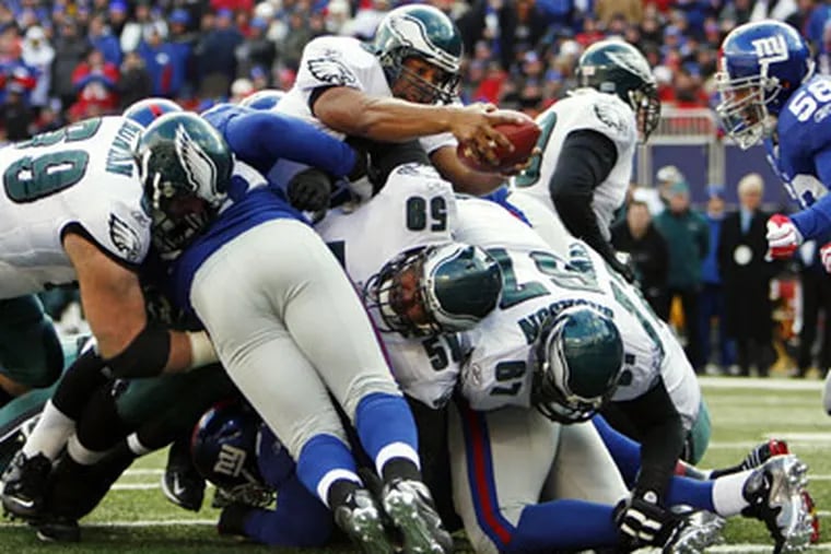 Donovan McNabb sneaks the ball over the goal line to score the game's first touchdown in the first quarter. The Eagles went on to beat the Giants, 23-11. (Eric Mencher / Staff Photographer)