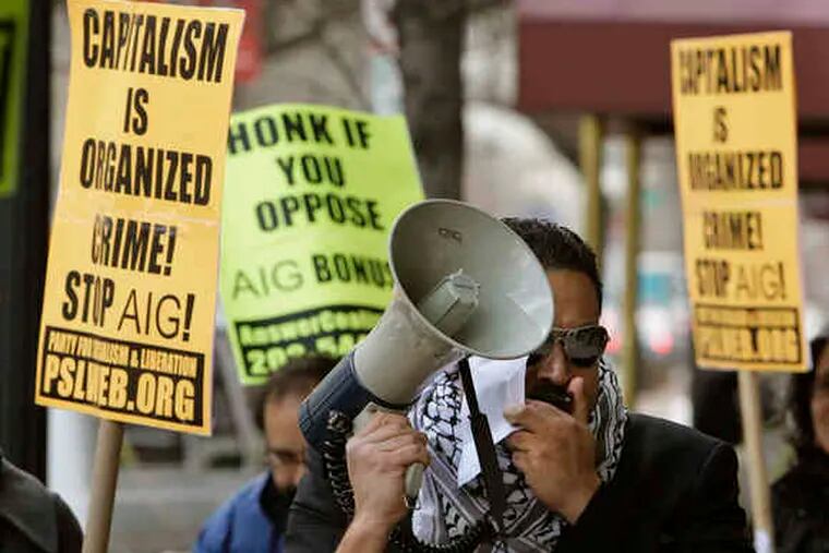 At a rally in March at AIG offices in Washington, Estevan Olivares uses a bullhorn to protest the company's bonuses.