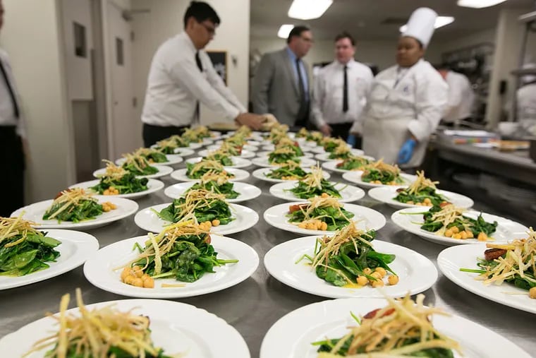 Students of the academy of culinary arts at ACCC, Carme's  in Mays Landing, prepare Springtime Salad made with wilted baby spinach, crispy leek, & charred tomato with a lemon-chive vinaigrette.