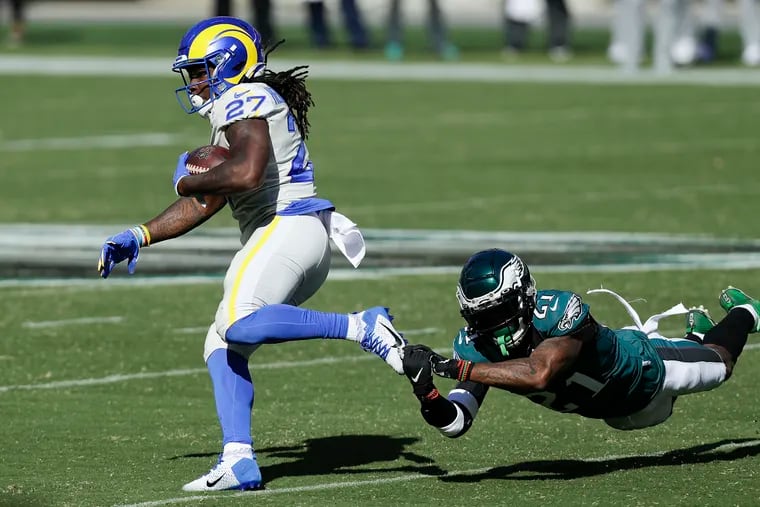 Eagles strong safety Jalen Mills dives after Los Angeles Rams running back Darrell Henderson during the fourth quarter of Sunday's 37-19 loss.
