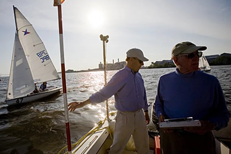 The Corinthian Yacht Club was established in 1892 in Essington, Pa. Here, Djoerd Hoekstra, left, Dr.Kaijhn Smith, right, officiate at a race. (Ed Hille / Inquirer)