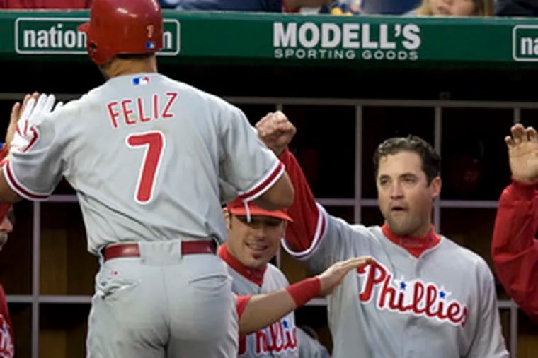 The Phillies&#0039; Pedro Feliz is greeted by Pat Burrell and other teammates after hittinga solo home run in the second inning against the Nationals.