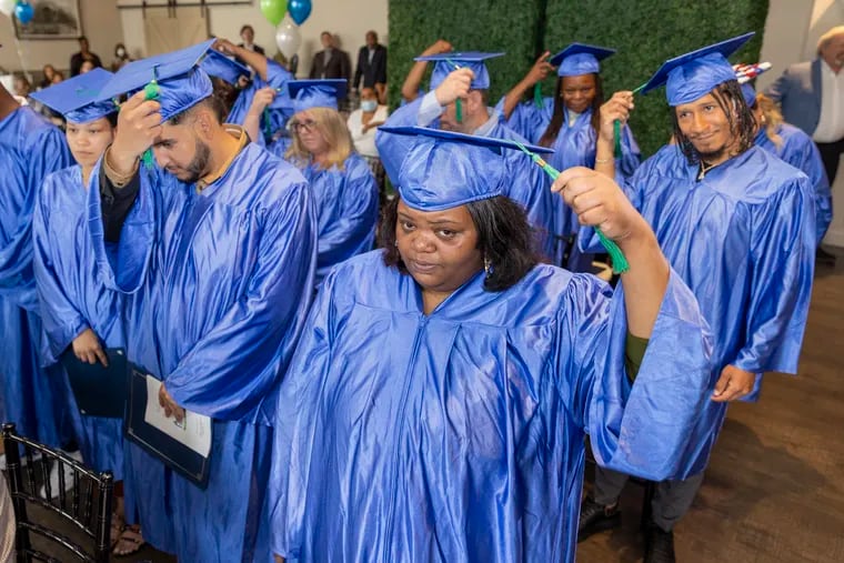 Naché Grant, 34, of Philadelphia, leads her classmates with the ceremonial turning of the tassels. They received high school diplomas at Goodwill's Helms Academy’s graduation ceremony at the Camden County Boathouse in Pennsauken, N.J. on Thursday, July 7, 2022.