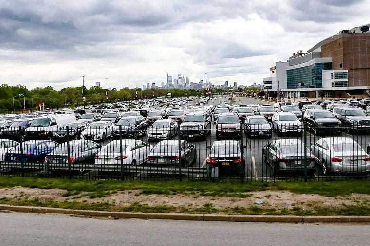 Hundreds of cars are parked at the D lots at the Wells Fargo Center in South Philadelphia.