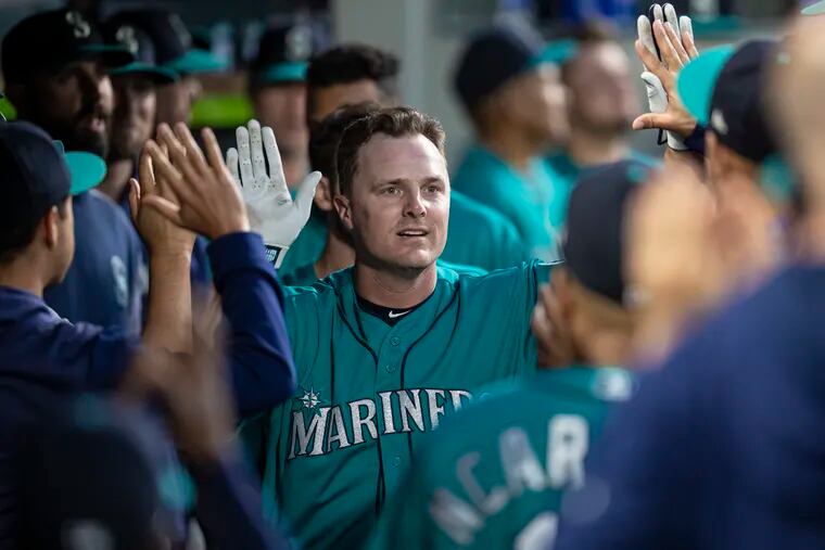 Seattle Mariners' Jay Bruce celebrates in the dugout after hitting a solo home run off Los Angeles Angels starting pitcher Tyler Skaggs during the seventh inning of a baseball game Friday, May 31, 2019, in Seattle.