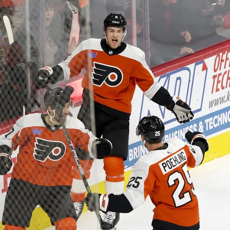 The Flyers' Travis Sanheim, center, celebrates his third-period goal against the Lightning on Tuesday at the Wells Fargo Center. Noah Cates is left and Ryan Poehling is right.