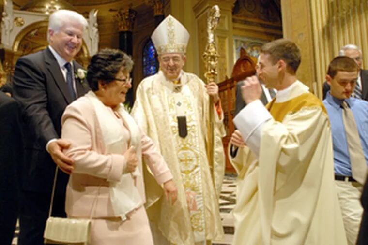 At his ordination at the Cathedral Basilica of SS. Peter and Paul in Philadelphia, Brian Kean (right) shares his joy with his parents, Bruce and Geraldine Kean, and Cardinal Justin Rigali.