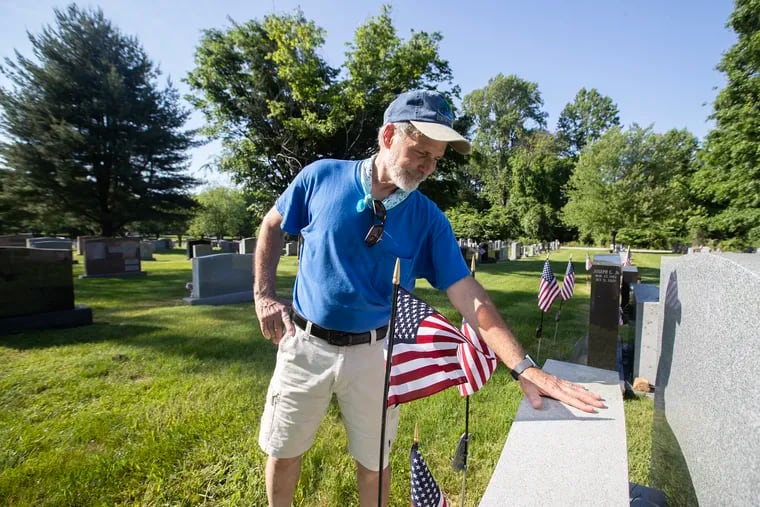 Ken Rucci, Sr., 70, of Westbrook Park, places flags on the grave of his father, Paul Rucci, a World War II Navy veteran. Rucci started the annual tradition in 2004, placing flags in memory of his father and other relatives.  It helped him deal with the loss of his father who had passed away in the fall of 2003. He now places approximately 500 flags on the graves of veterans at Saints Peter and Paul Cemetery in Springfield, Delaware County.  