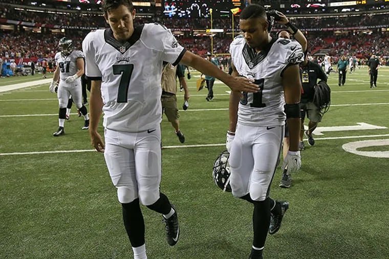 Eagles' Sam Bradford, left, gives Jordan Matthews, right, a pat as they walk off the field after the game. The Eagles lose 26-24 to the Atlanta Falcons at the Georgia Dome in Atlanta.