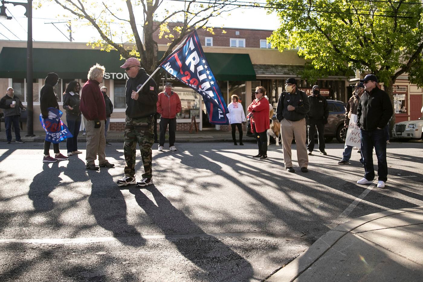 Community members stood in the street during a small rally outside of Giovanni's barbershop, supporting owner Nichole Missino's calls to the state to allow small businesses to reopen.