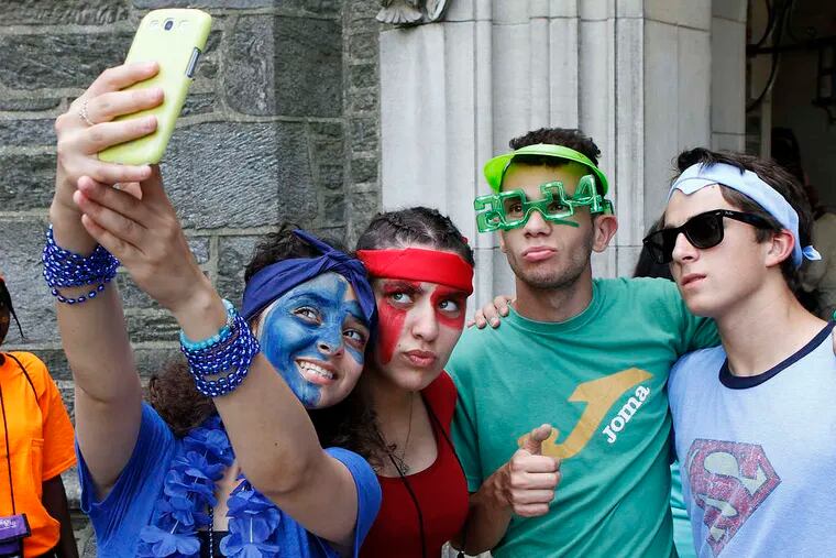 Palestinian Sarah Abutteen (from left) takes a group selfie with Radja Den Terkin of Algeria, John Candela of New Jersey, and Amine Aissaelbel of Algeria before the Peace Olympics games.
