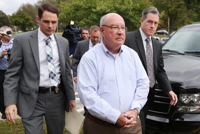 Radnor Township Commissioner Phil Ahr is walked to his arraignment at District Court in Newtown Square on charges of child sexual abuse and distributing and possessing child pornography Wednesday October 11, 2017. DAVID SWANSON / Staff Photographer