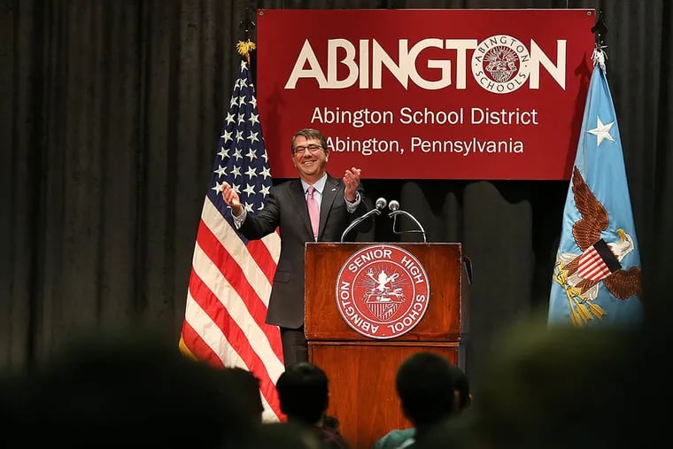 U.S. Secretary of Defense Ashton Carter acknowledges a standing ovation from the students at Abington Senior High School in Abington, Pa. on Mar. 30, 2015. Carter graduated from the high school in 1972.  ( DAVID MAIALETTI / Staff Photographer )