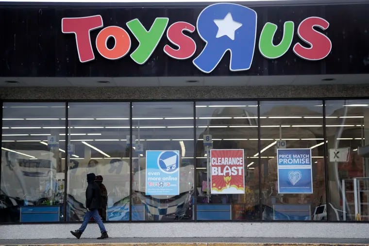FILE photo shows a person walking near the entrance to a Toys R Us store, in Wayne, N.J. Regulators and experts worry that leveraged corporate borrowing could mushroom, hurt economy and potentially trigger a downturn. (AP Photo/Julio Cortez, File)