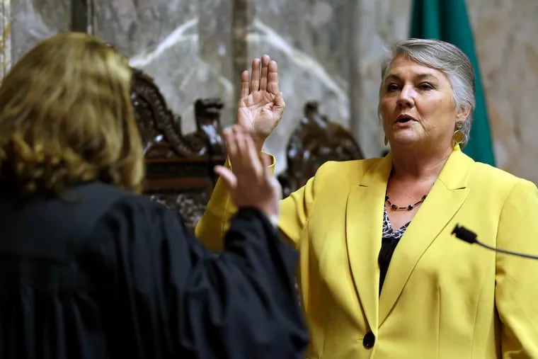 On Jan. 9, 2017, Sen. Maureen Walsh, R-Walla Walla, right, takes the oath of office on the opening day of the 2017 legislative session in Washington State. Sen. Walsh has angered nurses by commenting in a speech last week that nurses in rural hospitals may spend a lot of time playing cards.