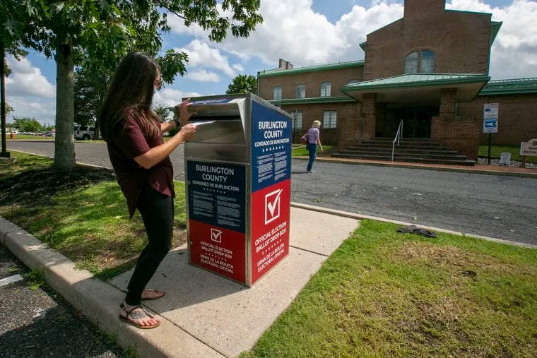 Ashley Power of Burlington County casts her mail-in ballot in the July primary, dropping it into a ballot box outside the Medford Township Public Safety building on election day.