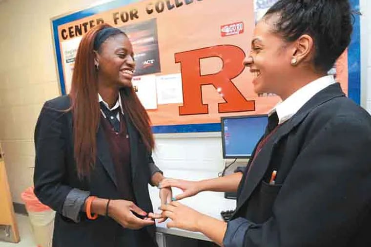 Kids from Future Scholars, a mentoring and scholarship program Rutgers started five years ago, on June 6, 3013. Here, at LEAP Academy, Brianna Walker, left, chats with classmate Geeniva Torres. ( APRIL SAUL / Staff )