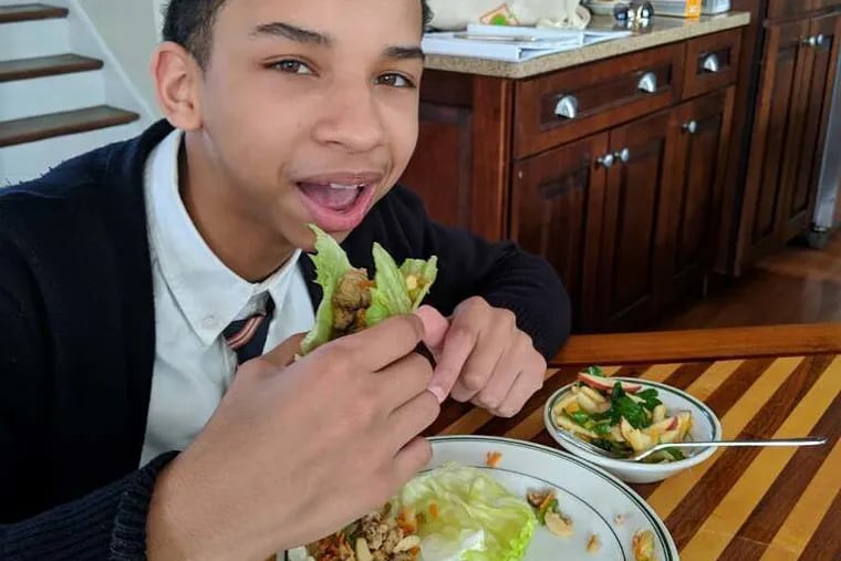 Jaden Mosley tries the turkey lettuce wraps that he and other students learned to make during week six of the spring 2019 My Daughter's Kitchen cooking program at Urban Promise.