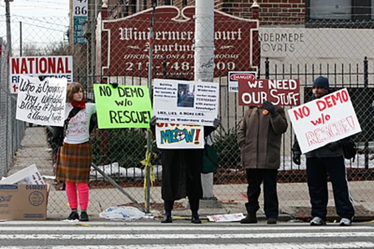 Residents of the Windermere Court apartments and animal-rights activists outside the fire-damaged complex at 48th and Walnut Streets on Monday. (Alejandro A. Alvarez / Staff)