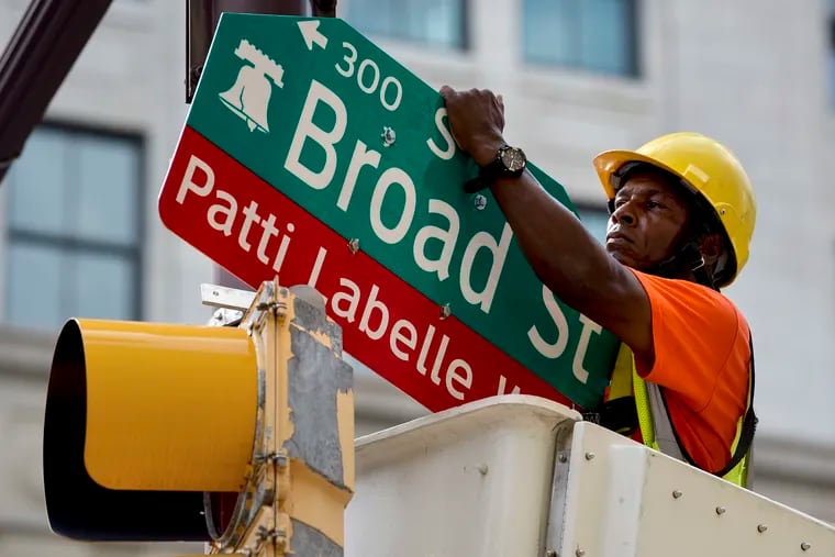 Traffic worker Elmer Heard with the Philadelphia Streets Department installs a new sign for Patti LaBelle Way at Broad and Spruce Streets July 2, 2019, before ceremonies honoring Patti LaBelle with the renaming of the block of Broad Street between Spruce and Locust Streets after her.