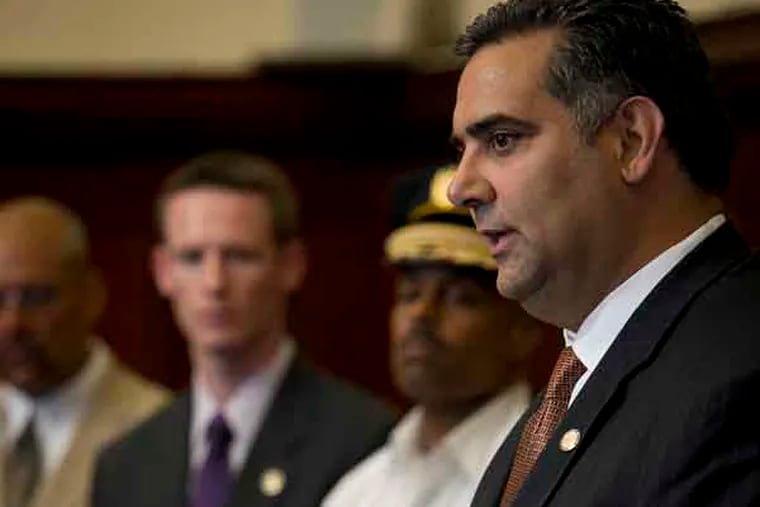 Managing Director Rich Negrin speaks to the media while gesturing like he is holding a gun as he speaks about gun violence and youth in the city. City officials gathered in the Mayors Reception Room to outline a long term approach to combating crime in Philadelphia. Photograph from Thursday, July 25, 2013. ( ALEJANDRO A. ALVAREZ / STAFF PHOTOGRAPHER )