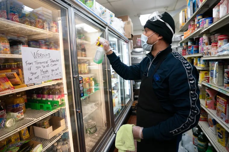 Pedro Reyes, a grocer at Wharton Grocery in South Philadelphia, has had policy since late March that customers must cover their mouth when they are in his store. This week, Pennsylvania health officials required all essential businesses in the state require employees and customers wear masks or facial coverings while inside.