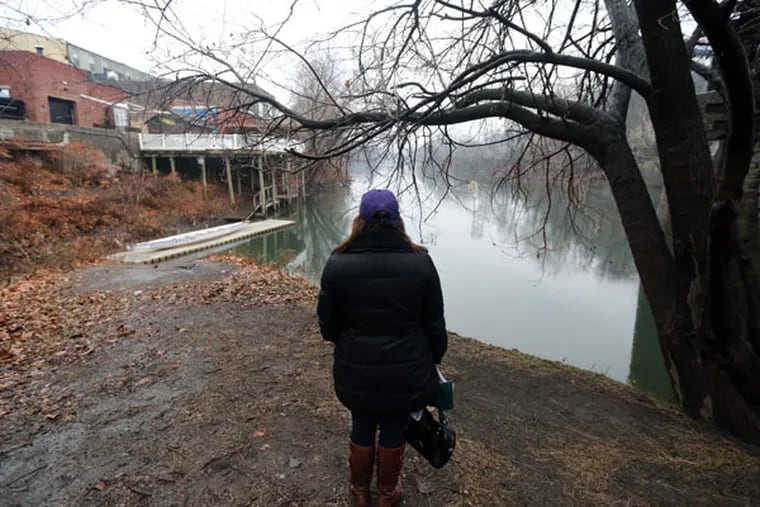 Gina Castle Bell, Shane Montgomery's professor of communications at West Chester University, looks out over the area near where the body of Shane Montgomery was recovered in Manayunk on Saturday, Jan. 3, 2015. ( DAVID SWANSON / Staff Photographer )