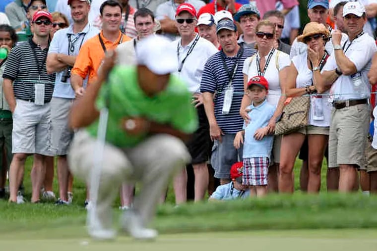The Aronimink gallery watches Tiger Woods prepare to putt on the course's third green. Some other AT&T National attendees found nearby concessions tents more attractive.