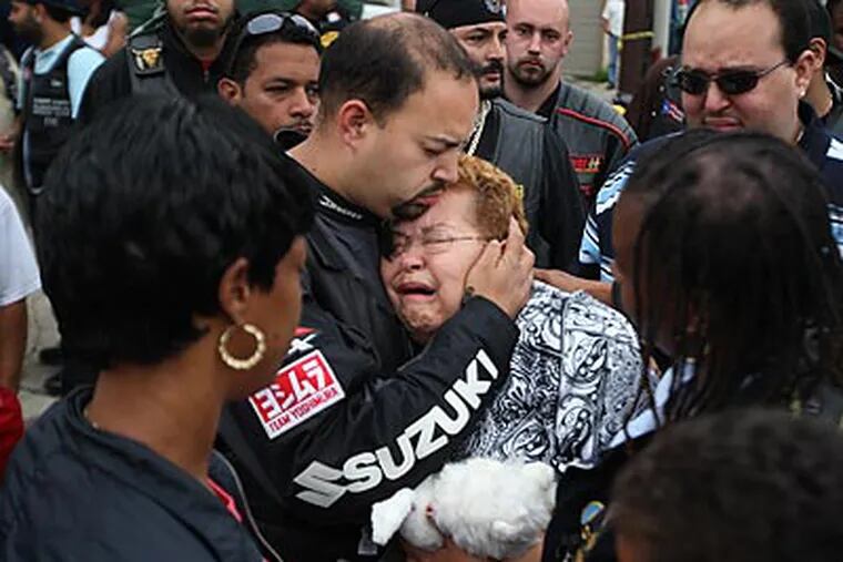 Luis Rosario gives his mother, Elsa Rosario a hug and a kiss as she cries about the death of her granddaughter, Gina Marie Rosario, in front of her home in Feltonville. (Michael Bryant/Staff Photographer)