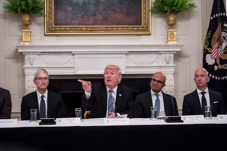 President Trump speaks in 2017, at the White House, during an American Technology Council roundtable with, from left, Tim Cook, Apple's chief executive; Satya Nadella, Microsoft's chief executive; and Jeffrey P. Bezos, founder and chief executive of Amazon.com, who owns The Washington Post.